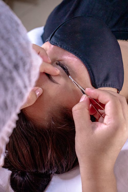 Cliente recevant des extensions de cils en institut, résultat visible et soigné.